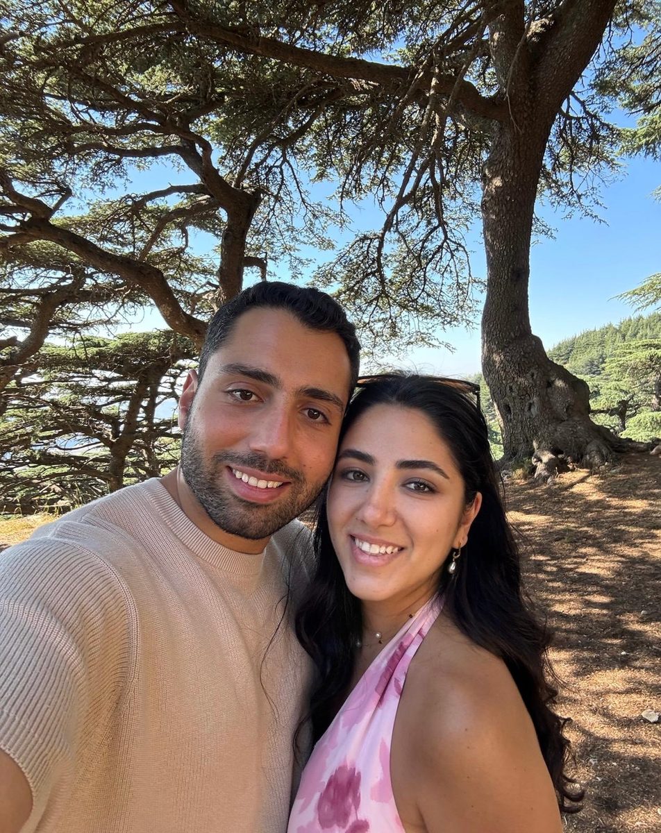 Raouf and Lea among tall evergreen trees