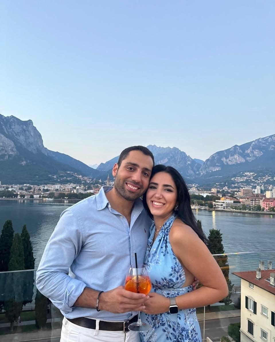 Raouf and Lea beside a mountain lake